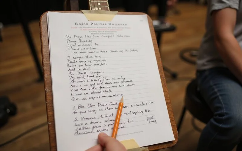 A handwritten set list on a music stand at an event