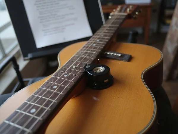 A capo and lyric sheet set up for a song